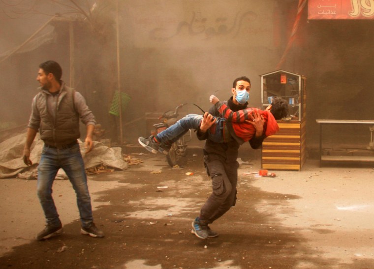A member of the Syrian Civil Defence carries an injured child in Douma on Feb. 7.