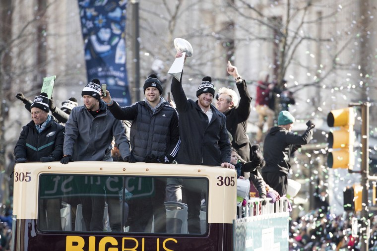 Philadelphia Eagles Carson Wentz, right, holds up the Vince Lombardi trophy as he rides with Nate Sudfeld, center right, Nick Foles, center left, and owner Jeffrey Lurie, left, during a Super Bowl victory parade on Feb. 8, 2018, in Philadelphia