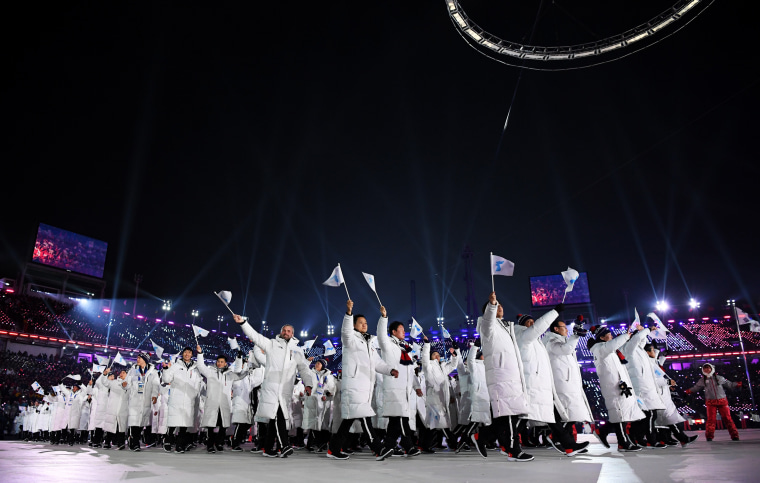 The North Korea and South Korea Olympic teams enter together under the Korean Unification Flag.
