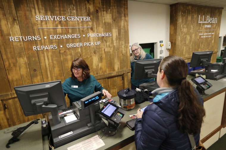 Image: Dawn Segars accepts a customer's returned items an LL Bean retail store