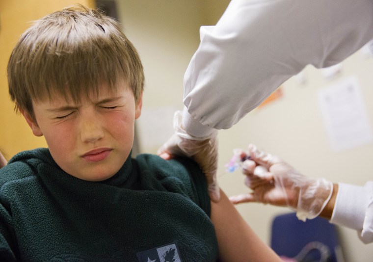 Image: Reed Olson, 8, gets a flu shot at a Dekalb County health center in Decatur, Georgia, on Feb. 5, 2018.