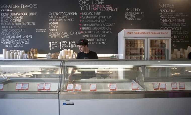 Image: Kyle Einerson, manager of the Clintonville retail location of Jeni's Splendid Ice Creams, reaches into the cooler for a scoop in Columbus, Ohio on June 10, 2011.