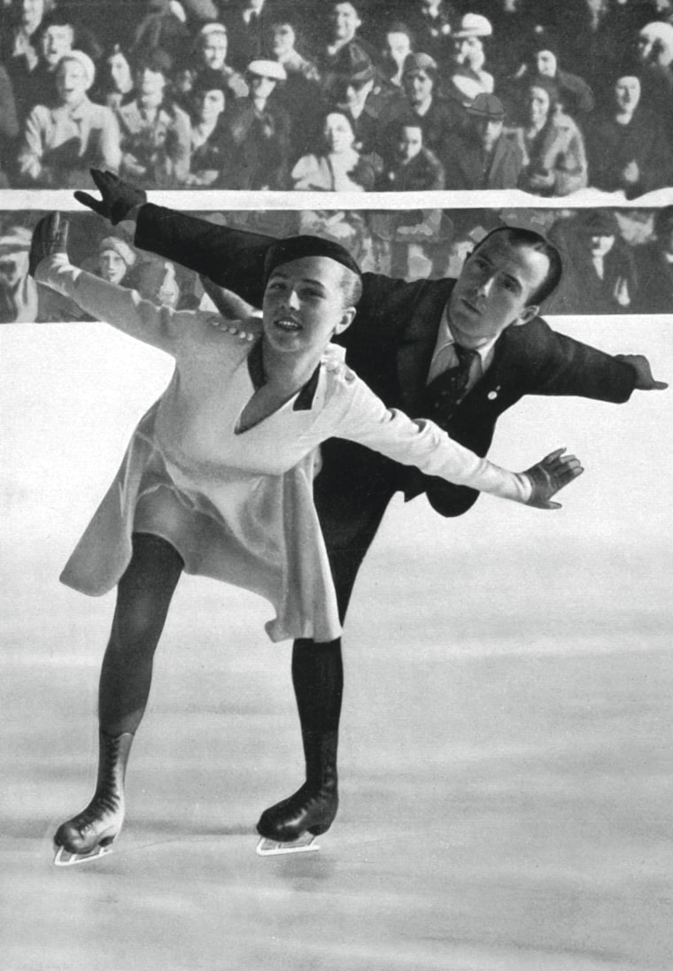 German Pairs figure skaters Maxi Herber and Ernst Baier at the Winter Olympic Games in Garmisch-Partenkirchen, Germany, in 1936. 
They won the gold medal in the event. She looks likkdressed like a stewardess and he, with his tie, is ready for a day at work.