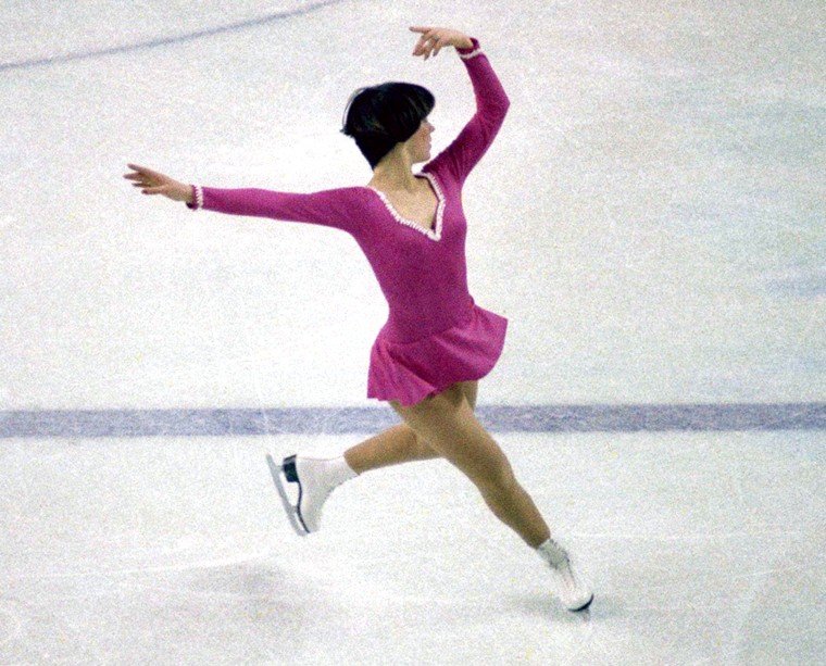 United States figure skater Dorothy Hamill in action during the 1976 Winter Olympic games held in Innsbruck, Austria. Hamill, who was known for her wedge haircut, wore a simple dress with a low neckline.