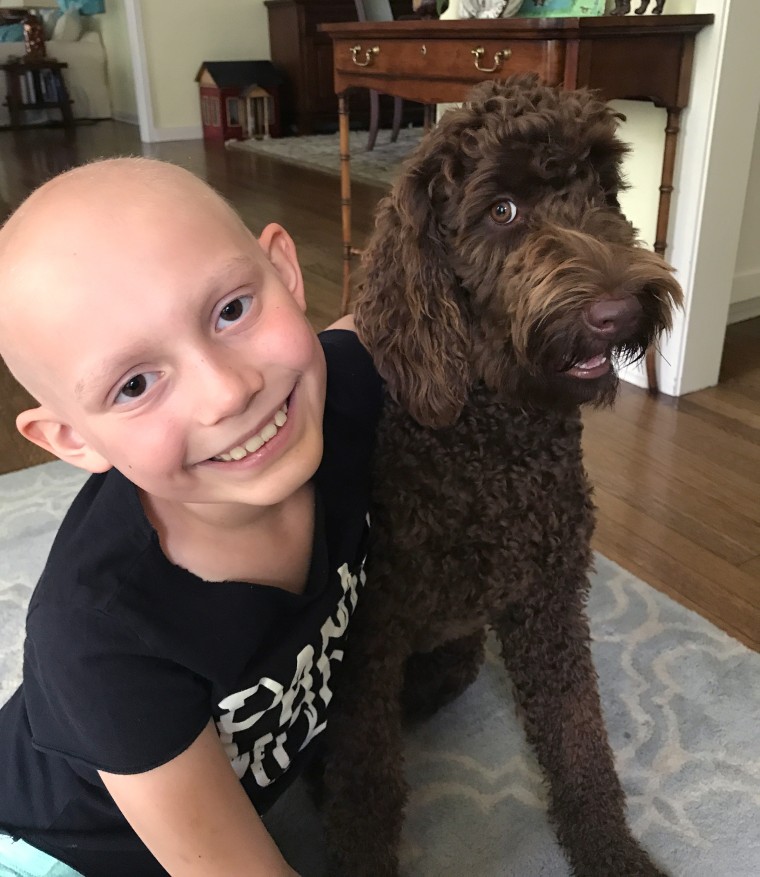 While she's feel bad after chemotherapy treatments, Riley likes hanging out with the family dog.