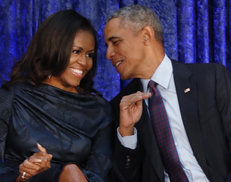 Image: The Obamas sit together at the unveiling of their portraits at the National Portrait Gallery in Washington