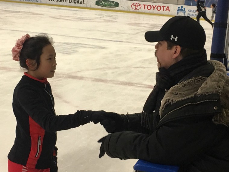 Galindo offers encouragement to young skater Elizabeth Ho.