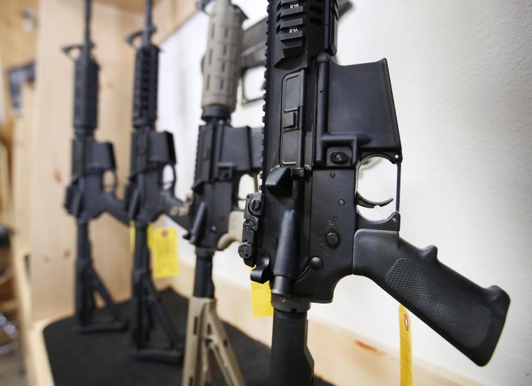 Image: AR-15 semi-automatic guns are on display for sale at Action Target o