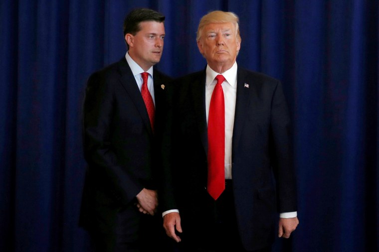 Image: White House Staff Secretary Rob Porter reminds U.S. President Donald Trump he had a bill to sign after he departed quickly following remarks at his golf estate in Bedminster, New Jersey on Aug. 12, 2017.