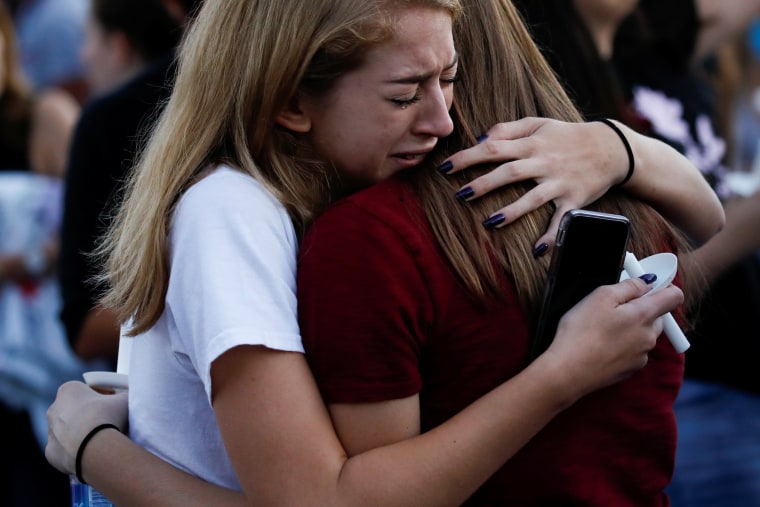 Students mourn during a candlelight vigil.