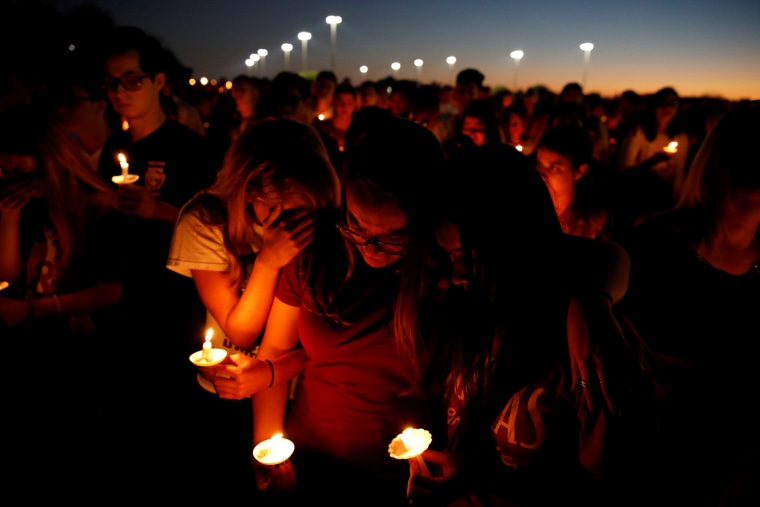 People attend a candlelight vigil.