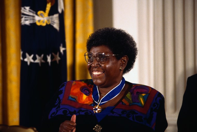 Image: Former Congresswomen Barbara Jordan smiles with a "thumbs up" as she receives a Presidential Medal of Freedom at the White House.