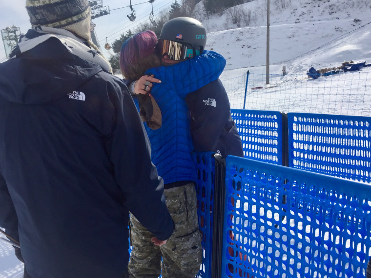 Devin Logan is comforted by her parents after the qualifying round for halfpipe skiing didn't go as planned.