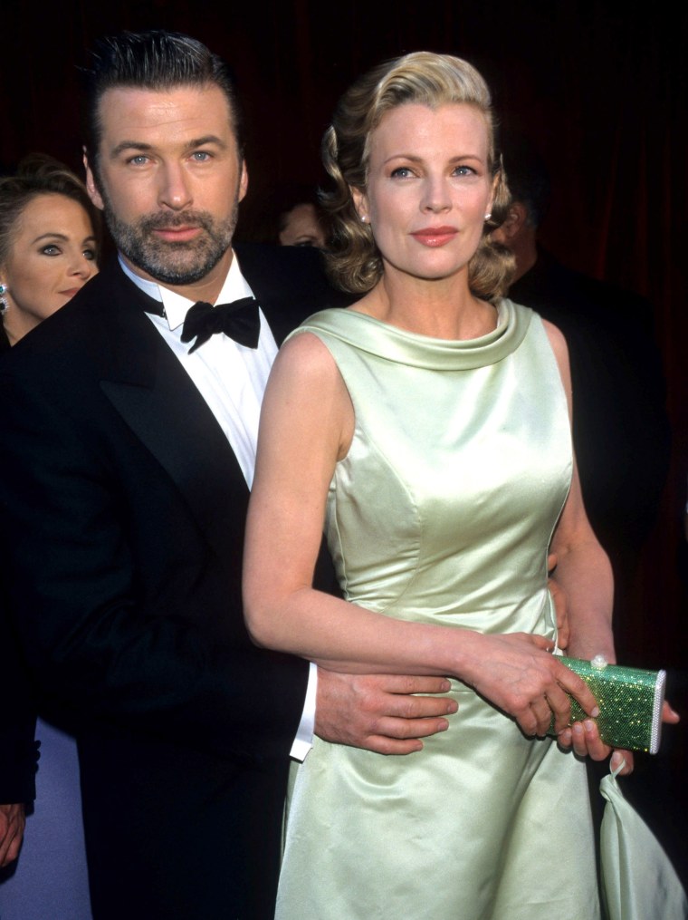 Alec Baldwin and Kim Basinger during The 70th Annual Academy Awards - Red Carpet at Shrine Auditorium in Los Angeles, California.