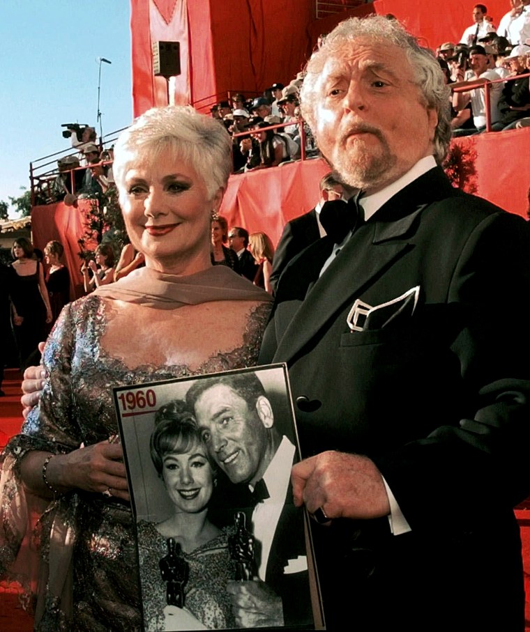 Marty Ingles shows off a picture of his wife, Shirley Jones, as they arrive at the 70th Academy Awards at the Shrine Auditorium in Los Angeles Monday, March 23, 1998. The picture, from 1960, shows Jones and Burt Lancaster after they won Oscars for their roles in \"Elmer Gantry.\"