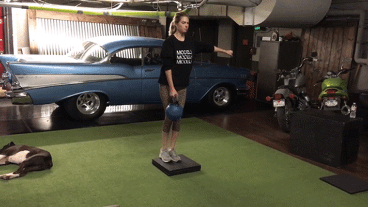 Kate Upton demonstrates how to do a reverse lunge with a weight.