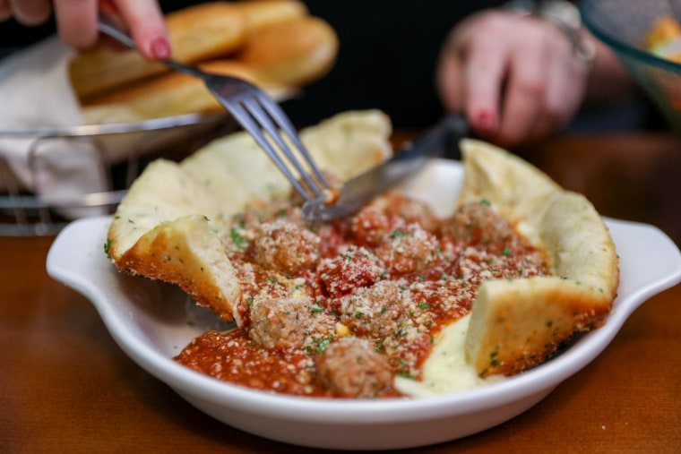 Olive Garden's new Meatball Bread Bowl is filled with meatballs, meat sauce and Italian cheeses in a pizza crust bowl.