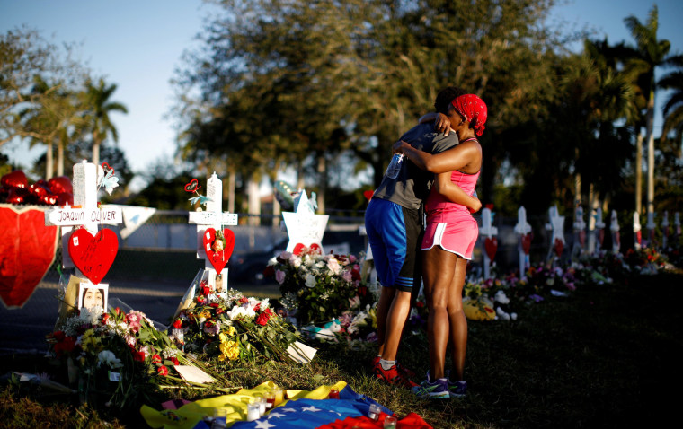 Image: A student embraced his mother at a memorial to the school shooting victims