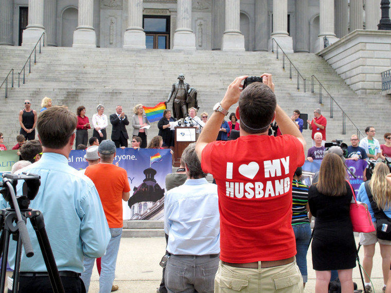 Image: Trevor Donovan takes pictures at a Statehouse rally