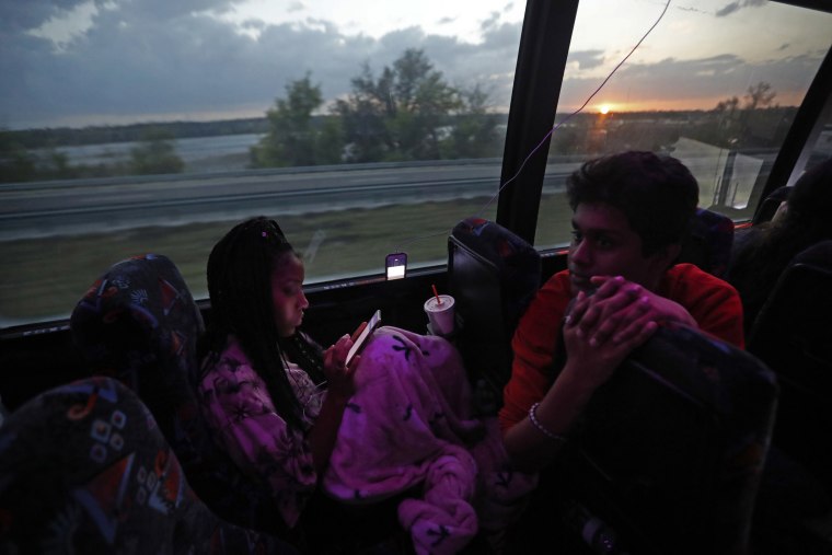 Image: Tyra Hemans, 19, left, and Tanzil Philip, 16, student survivors from Marjory Stoneman Douglas High School, speak on the bus