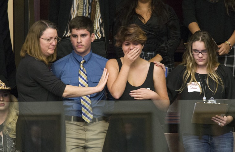 Image: Sheryl Acquarola a 16 year-old junior from Marjory Stoneman Douglas High School is overcome with emotion