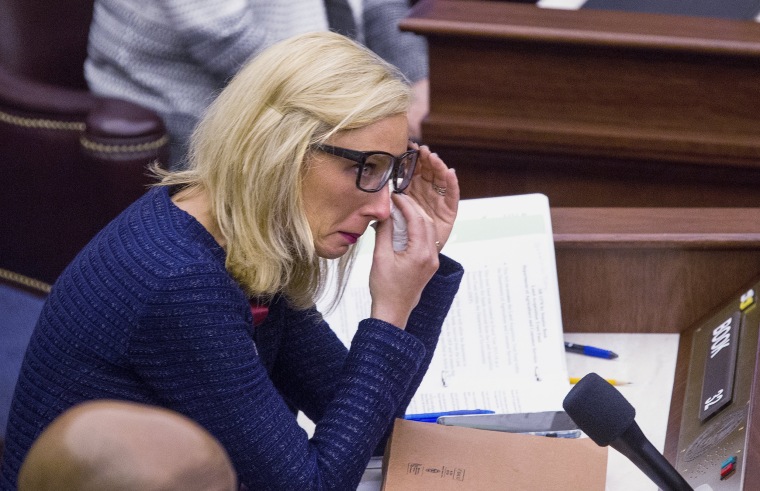 Image: Florida Sen. Lauren Book wipes her eyes after a memorial slide show