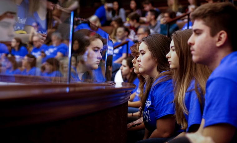 Image: Students from Marjory Stoneman Douglas High School look on from the gallery above the Florida Senate after the Senate honoured the victims of last week's mass shooting on their campus, in Tallahassee