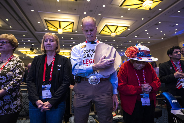 Image: Attendees say the Pledge of Allegiance at CPAC