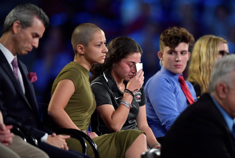 Image: Marjory Stoneman Douglas High School student Emma Gonzalez comforts a classmate during a CNN town hall meeting, at the BB&amp;T Center, in Sunrise