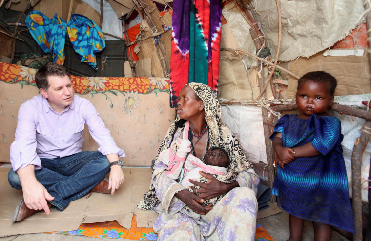 Image: FILE PHOTO: Forsyth, Chief Executive of Save the Children UK, talks to internally displaced Somalis at a camp in Hodan district of Somalia's capital Mogadishu