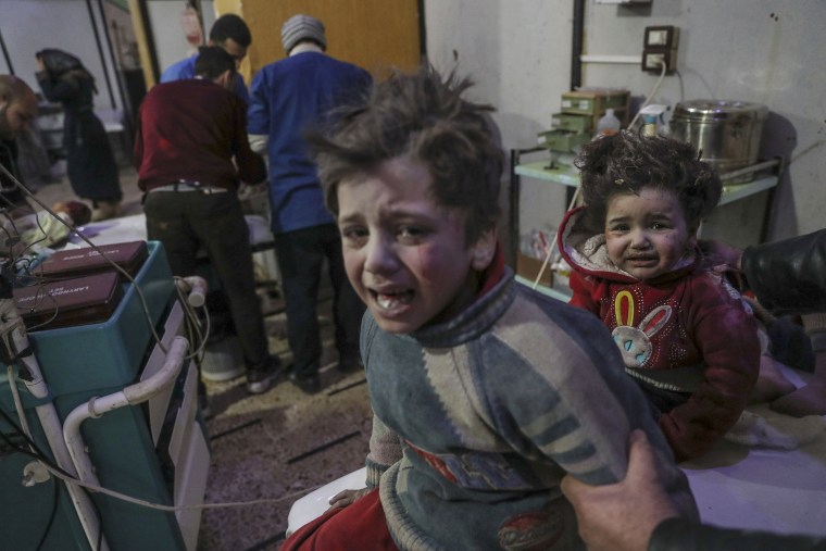 Injured children are treated at a hospital in rebel-held Douma, on Feb. 19.