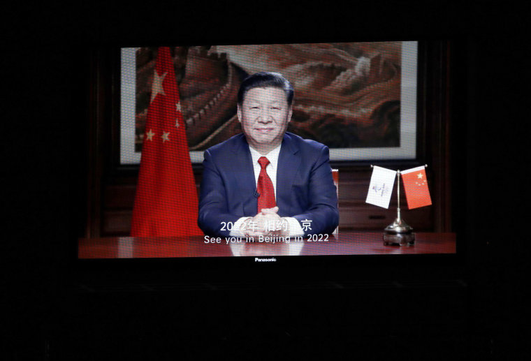 China's President Xi Jinping on screen in a video message sent for the closing ceremony.