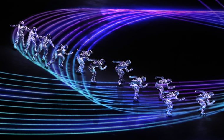 Artists perform a light show.