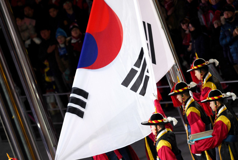 The South Korean Traditional Guard raises the Korean national flag.