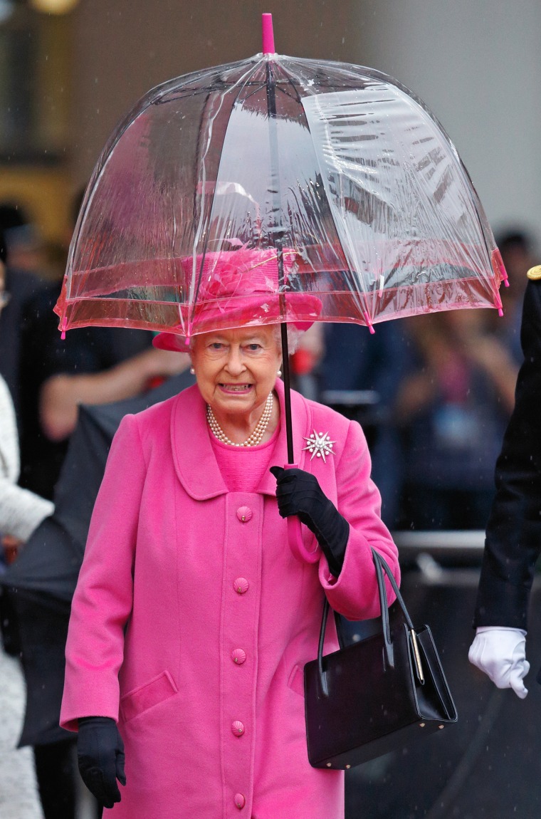 Queen Elizabeth II with umbrellas