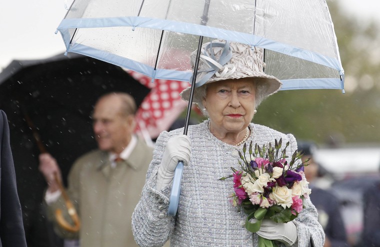 Queen Elizabeth II with umbrellas