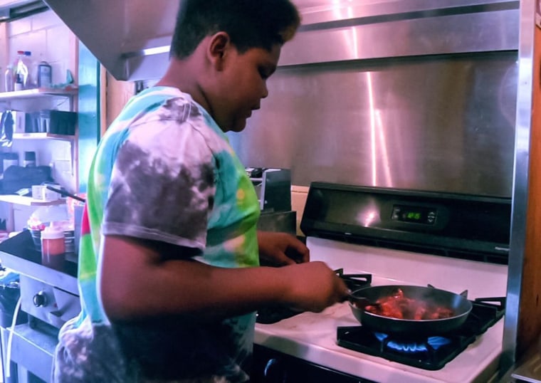 MasterChef Junior contestant Ben Watkins cooks at his family's restaurant Big Ben's Bodacious BBQ.