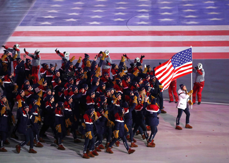 Image: Erin Hamlin of U.S. carries the national flag during the Olympics opening ceremony