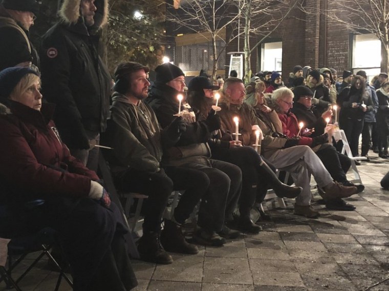 In this Feb. 13, 2018 photo, people hold a candlelight vigil to remember the victims of alleged serial killer Bruce McArthur in Toronto, Canada. 