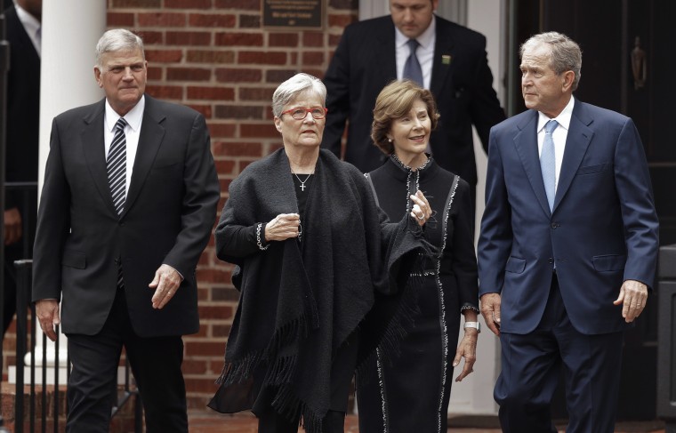 Image: George and Laura Bush after paying their respects to Billy Graham