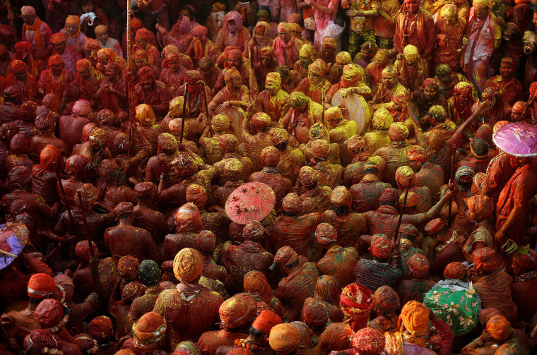 Image: Hindu devotees take part in the religious festival of Holi inside a temple in Nandgaon village