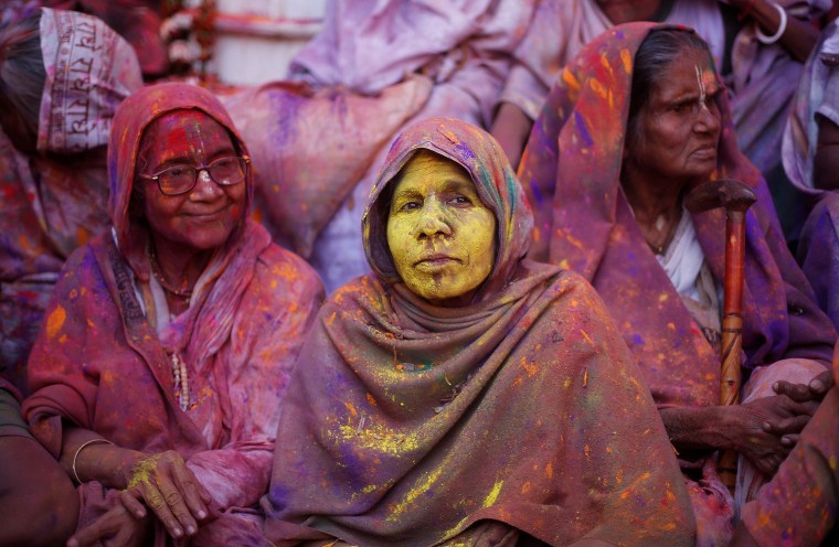 Image: Widows daubed in colours take part in Holi celebrations in the town of Vrindavan