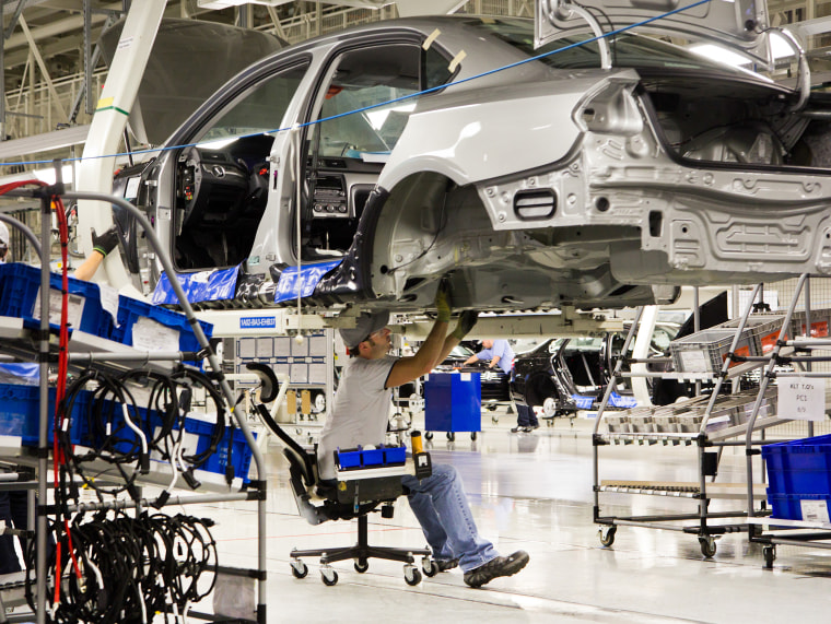 Image: An employee works on a Passat sedan at the Volkswagen plant in Chattanooga, Tennessee on July 31, 2012.