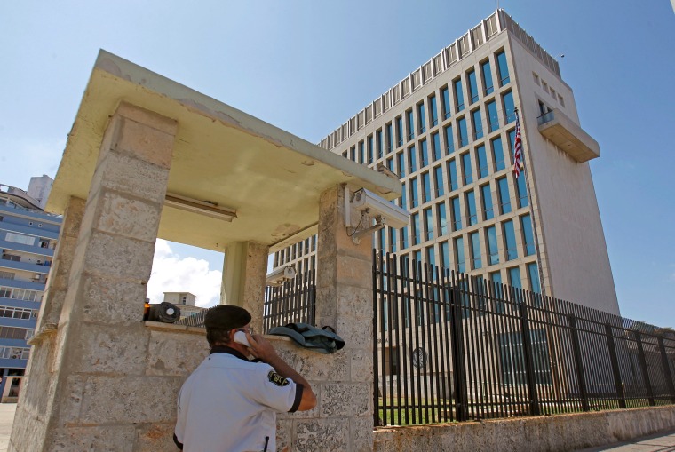 Image: A security guard uses a phone outside of the U.S. Embassy in Havana