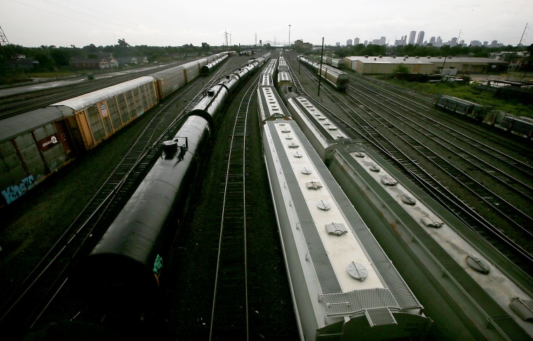 Image: Freight trains wait on railroad tracks