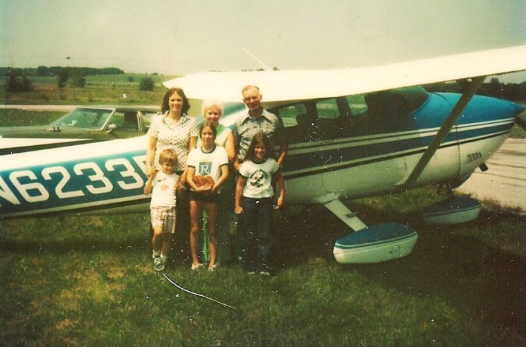 The Zarda family stands in front of an airplane during the mid-1970s. Mom (Shirley Zarda), Grandma (Elma Greer), Grandpa (Vester Greer), in front - (Donald), sister (Kimberly Zarda), sister (Gara Zarda).