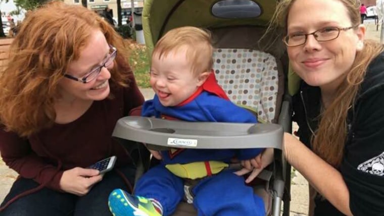 At 2-years-old Evan enjoys reading and signing to chat with his mothers.