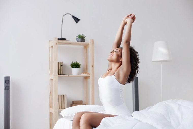 Image: woman stretching in bed