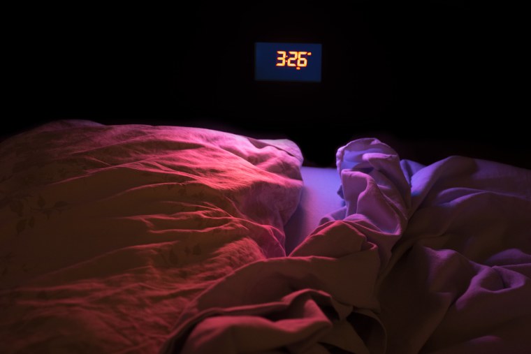 Image: The glow of an alarm clock in the middle of the night.