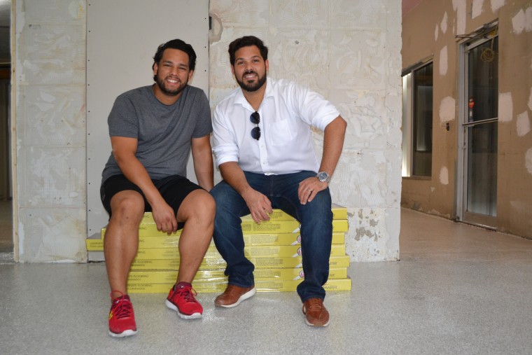 David Flores (L) and Ivan Nieves (R) inside the space they're renovating to open up their business in Miami's MiMo district. They left Puerto Rico in October.